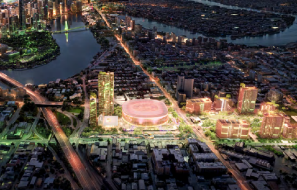 Artist impression showing a large mixed-use entertainment precinct with a modern arena, public spaces and surrounding buildings.